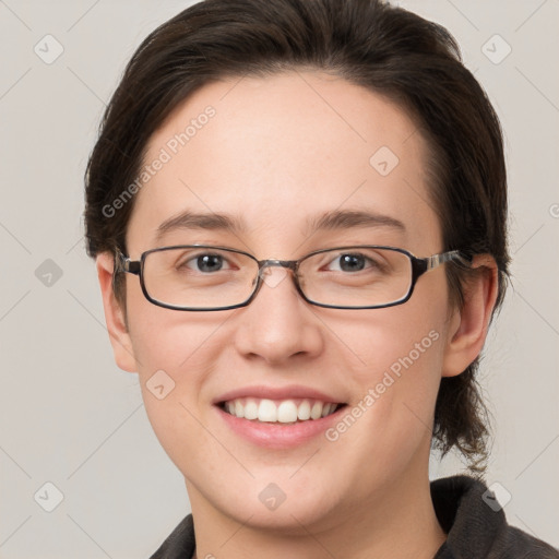 Joyful white young-adult female with medium  brown hair and grey eyes