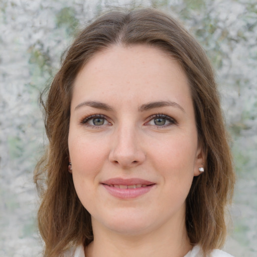 Joyful white young-adult female with medium  brown hair and green eyes