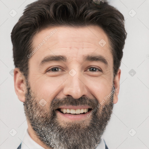 Joyful white adult male with short  black hair and brown eyes