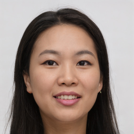 Joyful asian young-adult female with long  brown hair and brown eyes