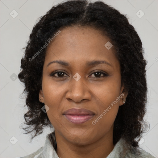 Joyful black adult female with medium  brown hair and brown eyes