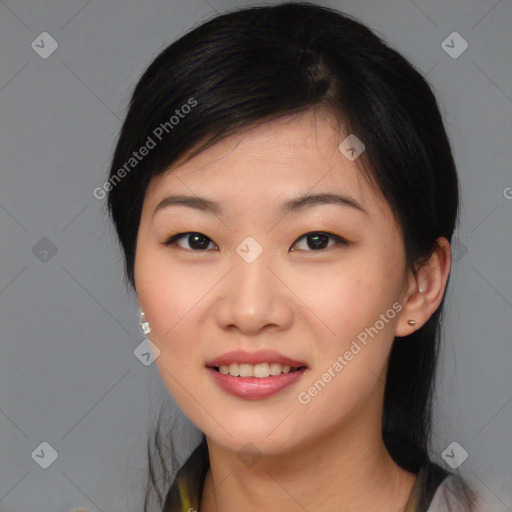 Joyful asian young-adult female with medium  black hair and brown eyes