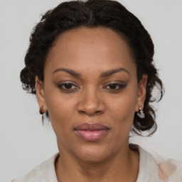 Joyful black adult female with short  brown hair and brown eyes