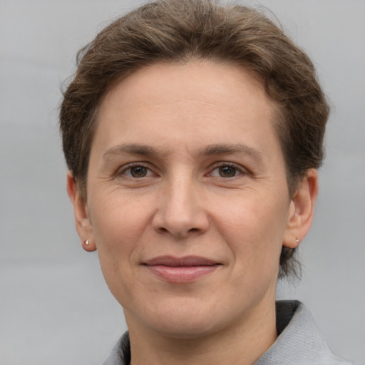 Joyful white adult female with short  brown hair and grey eyes