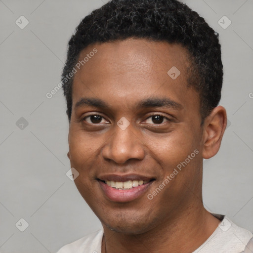 Joyful black young-adult male with short  black hair and brown eyes