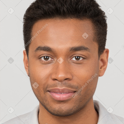 Joyful black young-adult male with short  brown hair and brown eyes