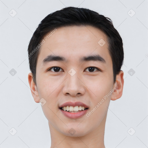 Joyful asian young-adult male with short  black hair and brown eyes