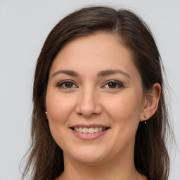 Joyful white young-adult female with long  brown hair and grey eyes