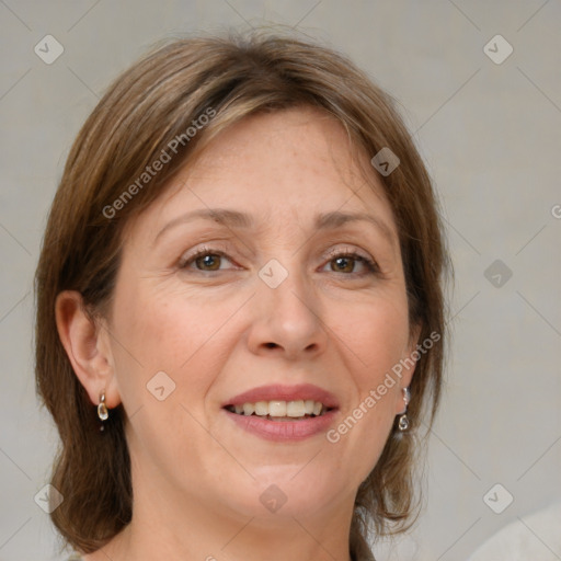 Joyful white adult female with medium  brown hair and green eyes