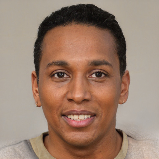 Joyful black young-adult male with short  black hair and brown eyes