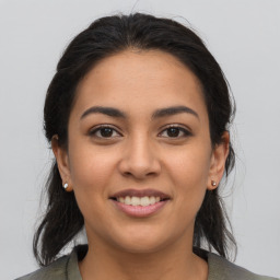 Joyful latino young-adult female with medium  brown hair and brown eyes