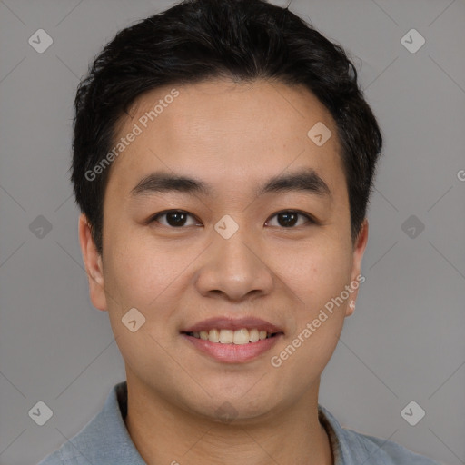 Joyful asian young-adult male with short  black hair and brown eyes