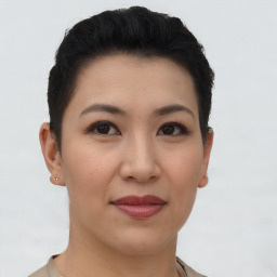 Joyful asian young-adult female with short  brown hair and brown eyes