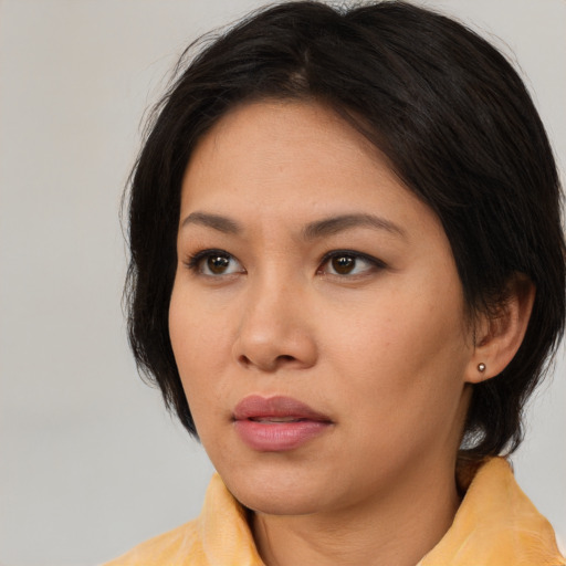 Neutral asian young-adult female with medium  brown hair and brown eyes