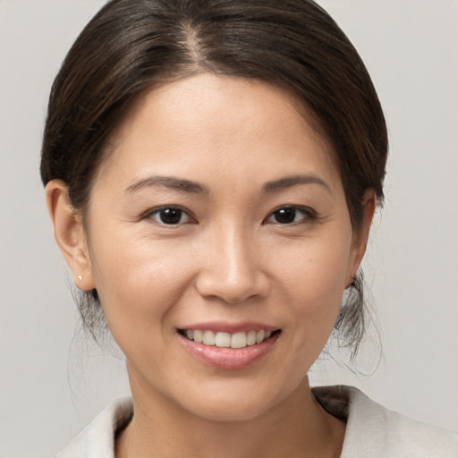 Joyful white young-adult female with medium  brown hair and brown eyes