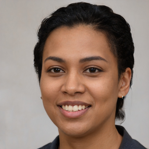 Joyful latino young-adult female with short  black hair and brown eyes