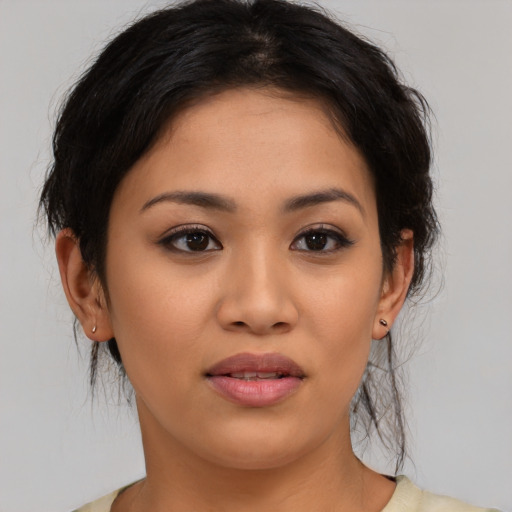 Joyful latino young-adult female with medium  brown hair and brown eyes