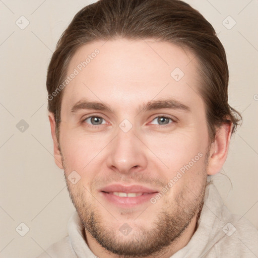 Joyful white young-adult male with short  brown hair and grey eyes