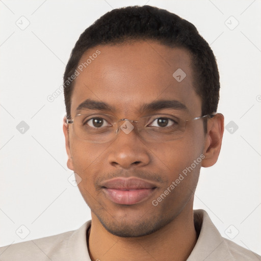 Joyful black young-adult male with short  brown hair and brown eyes