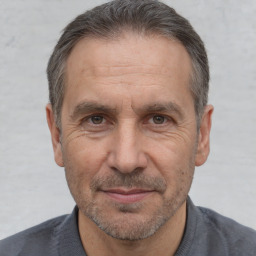 Joyful white middle-aged male with short  brown hair and brown eyes