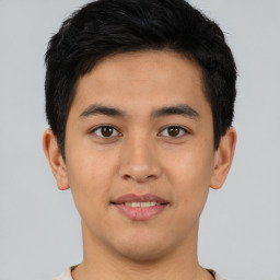 Joyful asian young-adult male with short  black hair and brown eyes