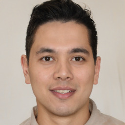 Joyful latino young-adult male with short  brown hair and brown eyes