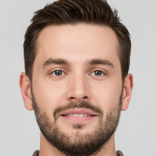 Joyful white young-adult male with short  brown hair and brown eyes