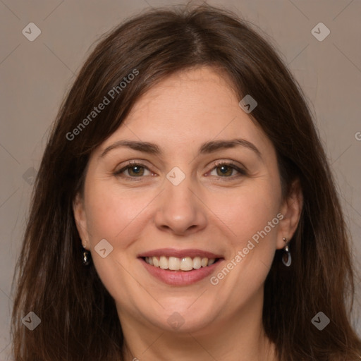 Joyful white adult female with long  brown hair and grey eyes