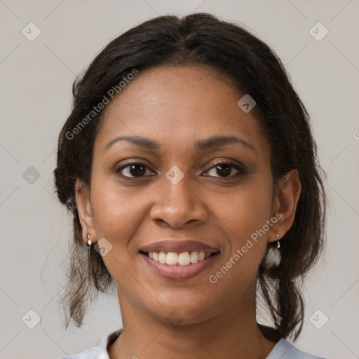 Joyful black young-adult female with medium  brown hair and brown eyes