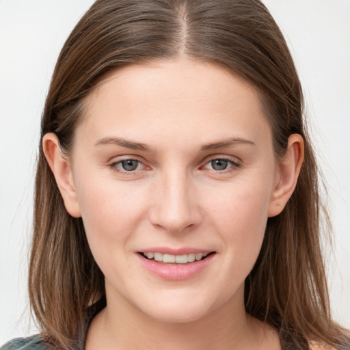 Joyful white young-adult female with long  brown hair and grey eyes