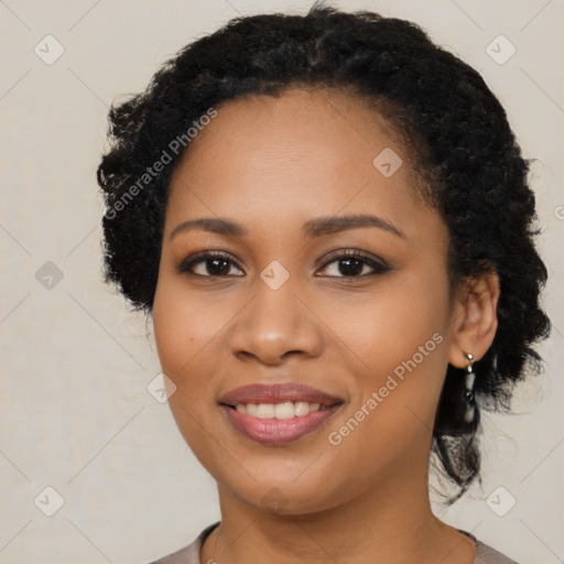 Joyful black young-adult female with long  brown hair and brown eyes