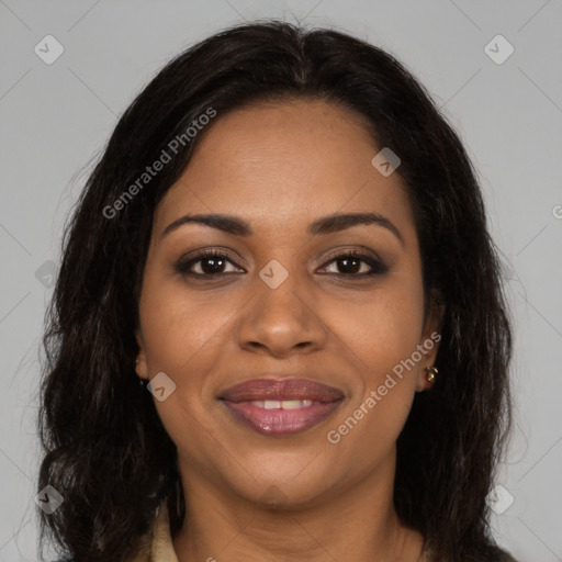 Joyful black young-adult female with long  brown hair and brown eyes