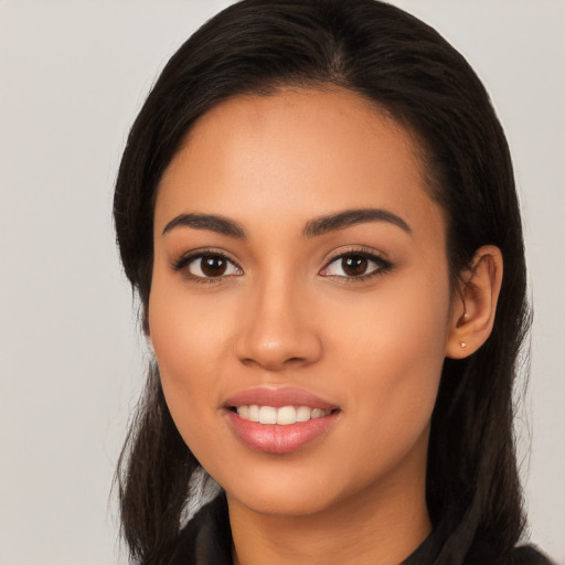 Joyful latino young-adult female with long  black hair and brown eyes