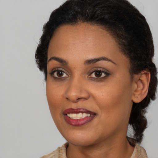 Joyful black young-adult female with medium  brown hair and brown eyes