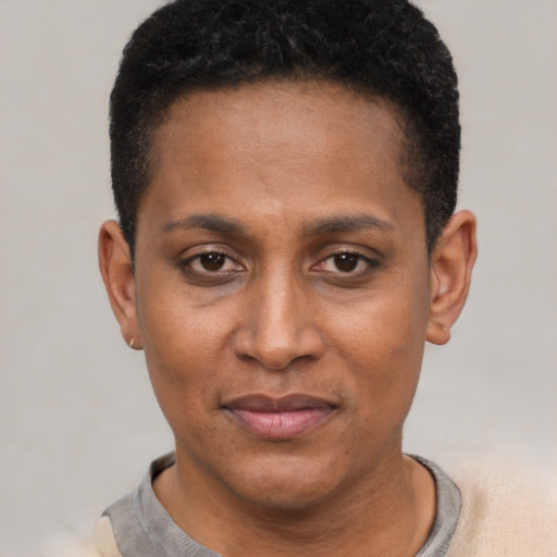 Joyful black young-adult female with short  black hair and brown eyes