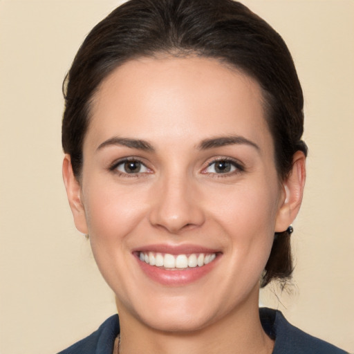 Joyful white young-adult female with medium  brown hair and brown eyes