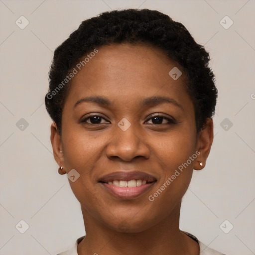 Joyful black young-adult female with short  brown hair and brown eyes