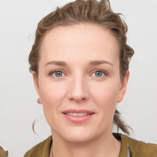 Joyful white young-adult female with medium  brown hair and blue eyes