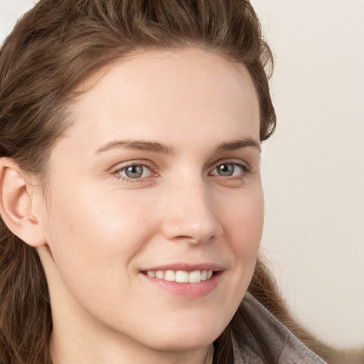 Joyful white young-adult female with long  brown hair and grey eyes