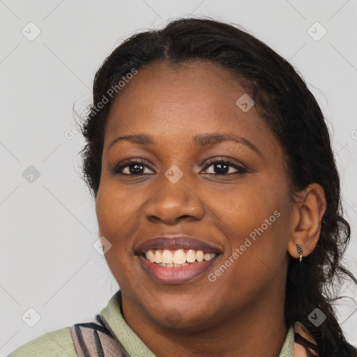 Joyful black young-adult female with long  brown hair and brown eyes