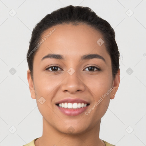 Joyful latino young-adult female with short  black hair and brown eyes