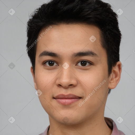 Joyful latino young-adult male with short  brown hair and brown eyes