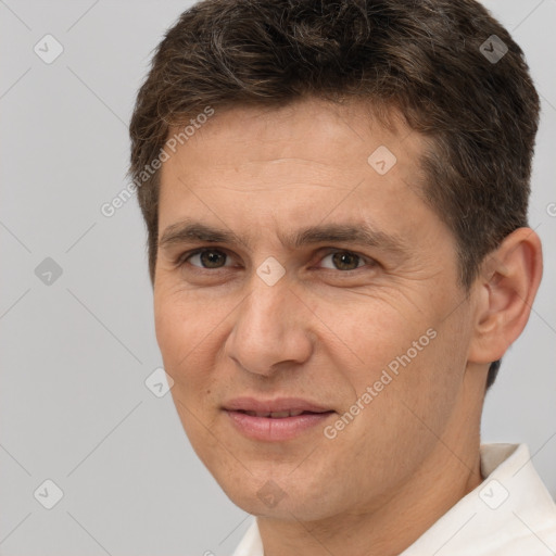 Joyful white adult male with short  brown hair and brown eyes