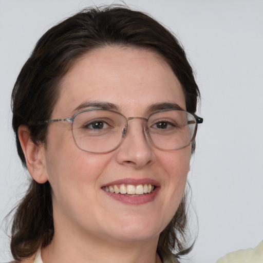 Joyful white young-adult female with medium  brown hair and blue eyes