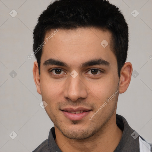 Joyful white young-adult male with short  black hair and brown eyes