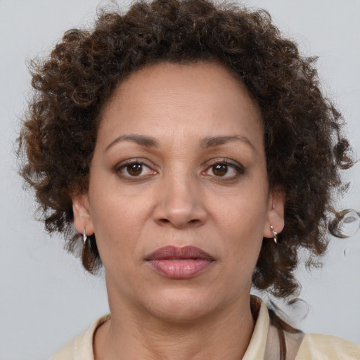 Joyful black adult female with medium  brown hair and brown eyes