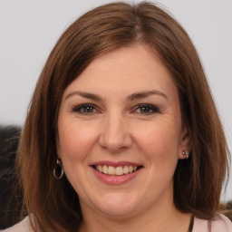 Joyful white adult female with medium  brown hair and brown eyes