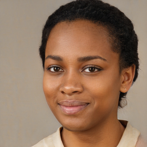 Joyful black young-adult female with medium  black hair and brown eyes