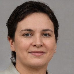 Joyful white adult female with medium  brown hair and brown eyes