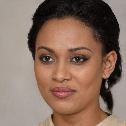 Joyful black young-adult female with medium  brown hair and brown eyes